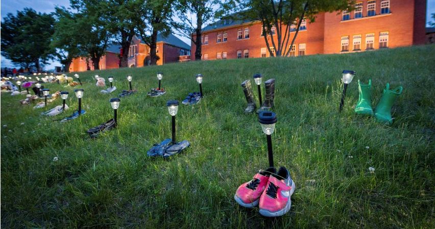Children’s shoes and toys were placed in a makeshift memorial outside the grounds of the former Kamloops Indian Residential School in British Columbia, where the remains of hundreds of Indigenous children have been discovered in unmarked graves.