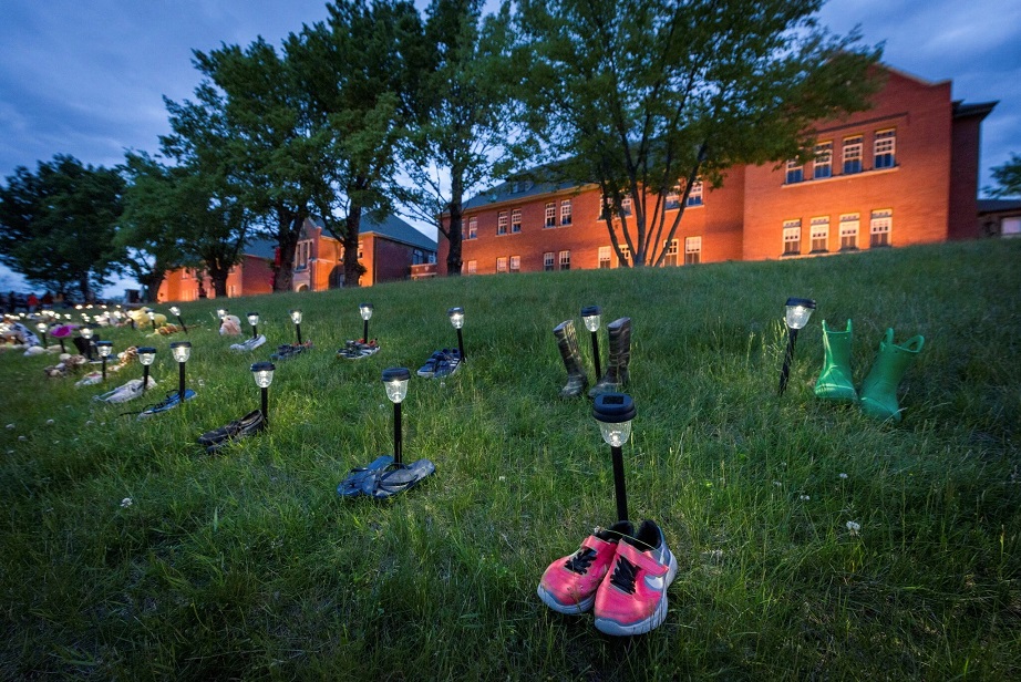 Children’s shoes and toys were placed in front of the former Kamloops Indian Residential School in British Columbia after the remains of 215 children, some as young as 3, were found at the site