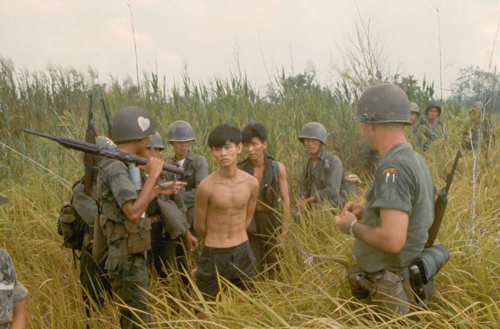A group of South Vietnamese army soldiers and an American soldier with two captured Vietcong suspects, in Plaines des Joncs, South Vietnam.Credit...Tim Page/Corbis, via Getty Images