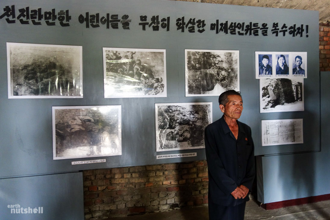  “Let’s get revenge on the imperialist murderers who brutally murdered our innocent children!” Photo taken in Sinchon. This man is one of the three survivors pictured to the right of an alleged massacre by the United States of women and children in a nursery. Just outside is a giant mural depicting American soldiers murdering women and throwing and stepping on the necks of children.