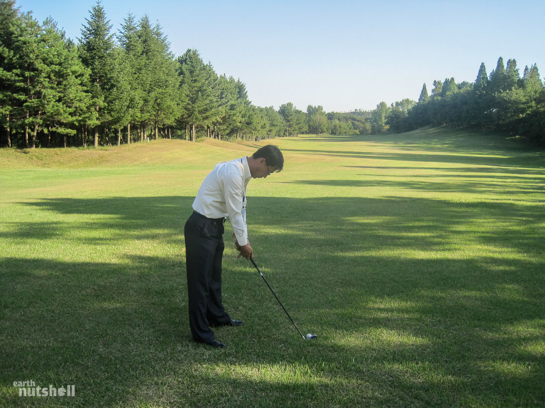  This is one of my guides taking his first ever golf shot at Pyongyang Golf Course. He had never heard of golf before today and he took a real liking to it. A 4 hour round turned into 6 hours as he was adamant on learning.