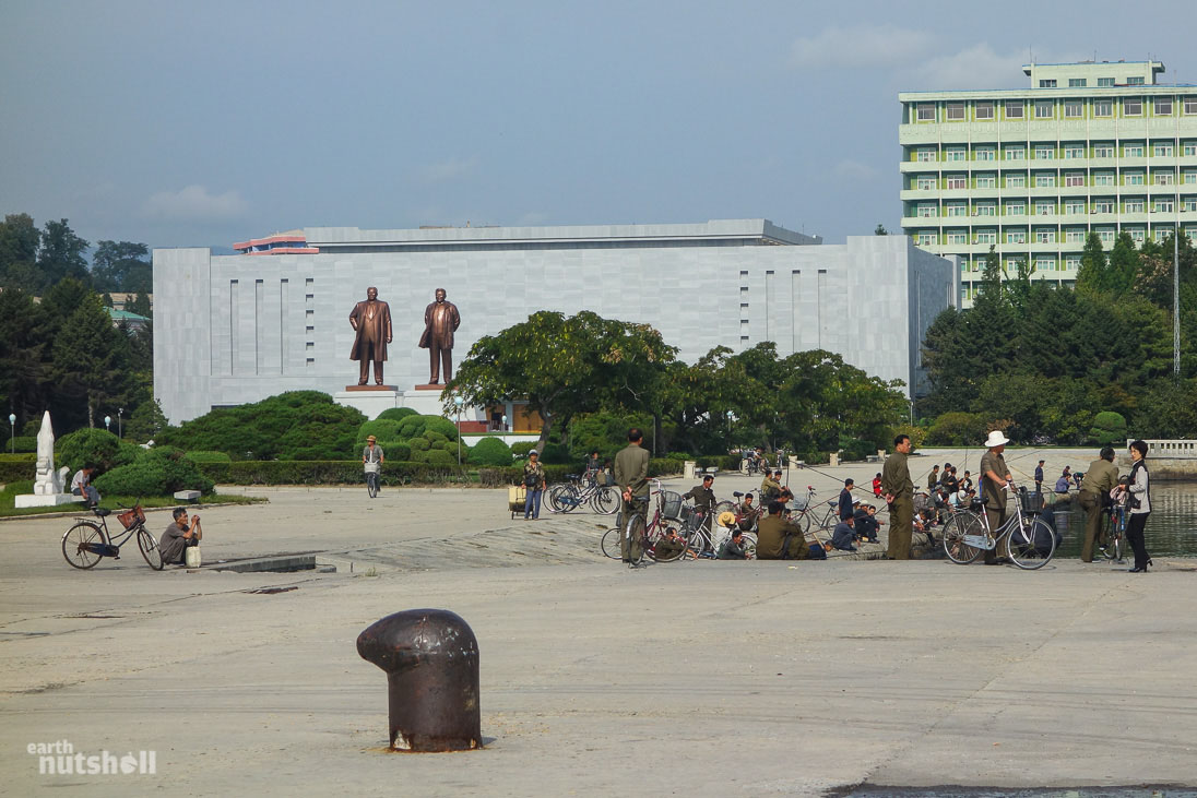 Statues of President Kim Il-Sung and General Kim Jong-Il watch over Wonsan harbour as locals spend their morning fishing. Seafood is plentiful in this city.