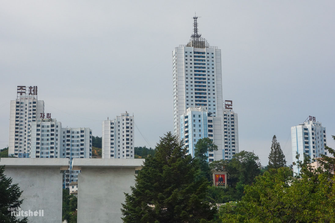 Tall white buildings scatter the hillside like mushrooms, intimidating the port city of Wonsan.