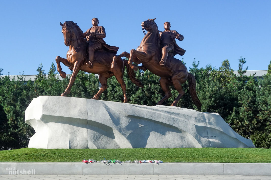 Flowers lay at the foot of an exemplary monument of the Great Leaders at the Mansudae Art Studio, Pyongyang. Mansudae Art Studio is the only studio permitted to depict the likeness of the hereditary Kim family.