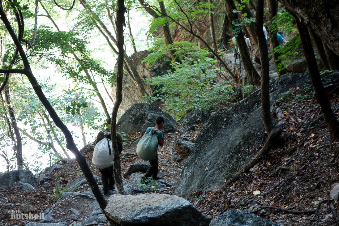  Locals seen tirelessly carrying sacks up and down Manphok Valley at Mt. Myohyang for weight training. Some are very young.