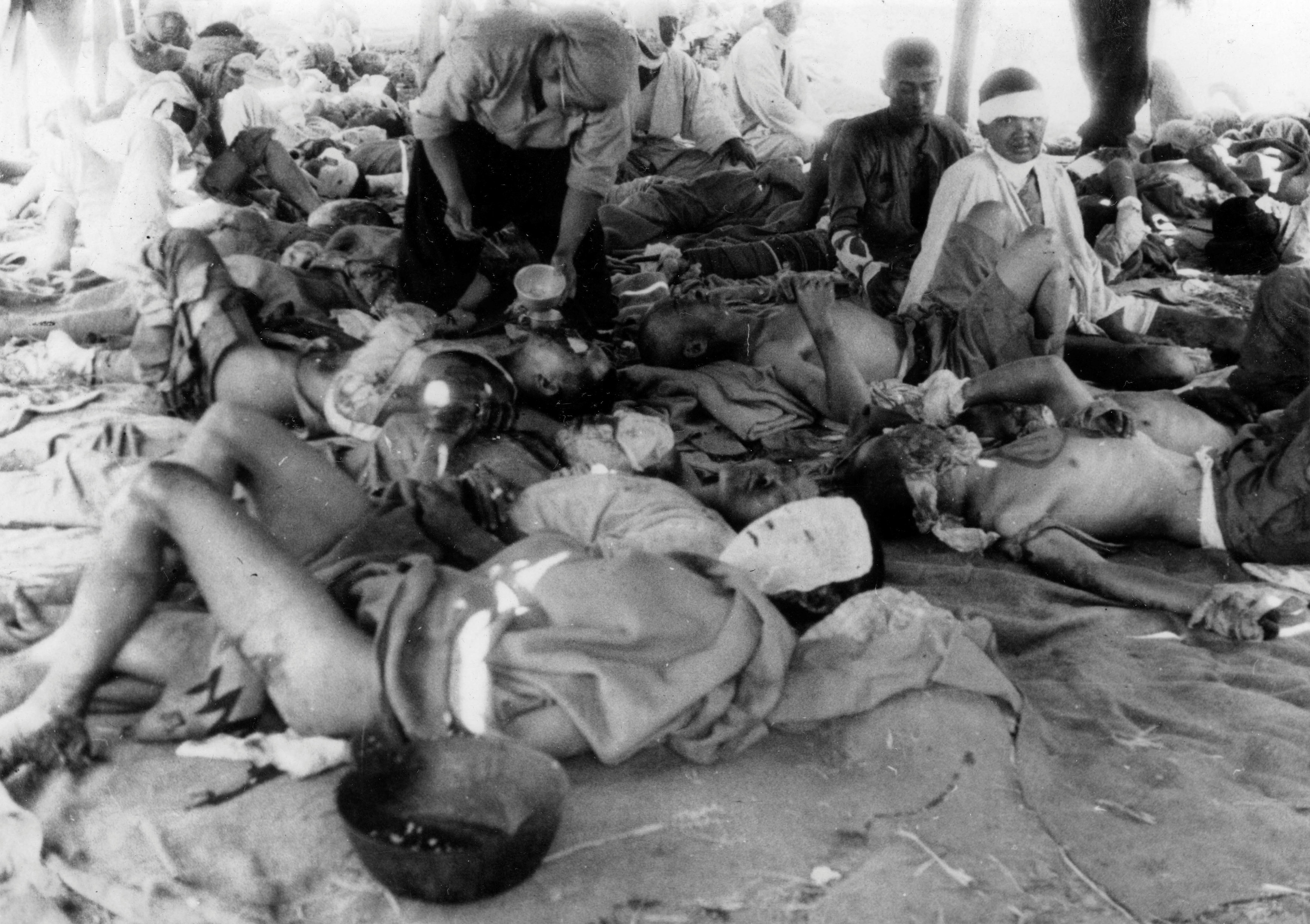  In a photo taken by Yotsugi Kawahara on Aug. 9, 1945, victims of the Aug. 6 atomic bombing seek treatment at an emergency relief station next to the Otagawa


